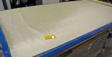 14609 Kevlar/Glass rolled out Glass layup table Kevlar/Glass 14609 ready to laminate with epoxy