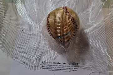 1659 1.6 oz leno weave fiberglass cloth shaped around baseball