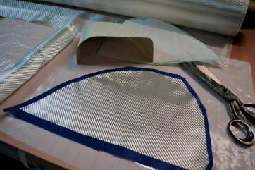 Style 7725 fiberglass cloth being cut using masking tape  from Thayercraft
