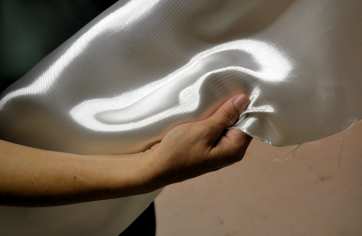 8.95 oz Style 7781 Volan finish fiberglass cloth from Thayercraft Julissa arm holding 7781 504 volan