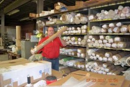 Steve Thayer, President of Thayercraft with short rolls of fiberglass cloth Steve Thayer, President of Thayercraft with short rolls of fiberglass cloth